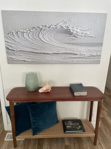 Reviewer's Minimalist Wall Art V with a 3D textured wave, hung above a wooden console table in a hallway.
