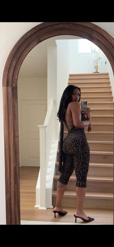 Reviewer's mirror selfie from the back, showing the halter tie and fit of the Burnout Print Capri Jumpsuit.