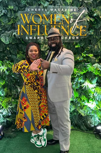 Customer wearing the Gilda African Print Tie-Neck Midi Dress while posing at a business event.