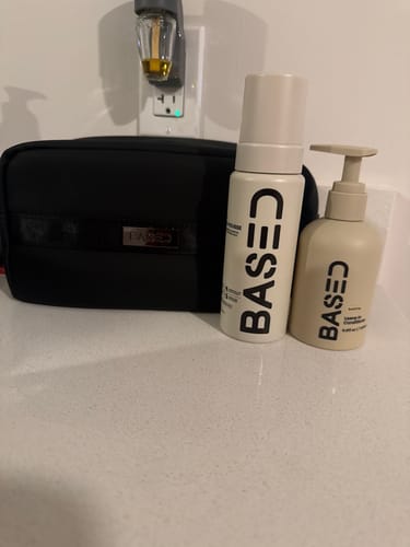 Customer's Hydration & Volume Duo products and black toiletry bag displayed on a white bathroom counter.