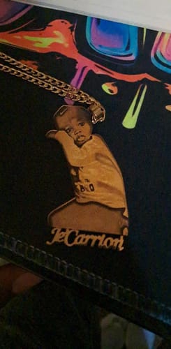 Customer's custom photo engraved pendant necklace, shaped like a person with an engraved image and name on the front.