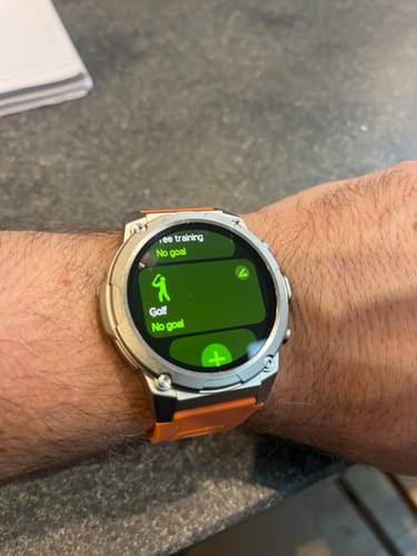 Customer's Gard Pro Ultra 3 smartwatch on their wrist with an orange band. The screen shows the golf tracking feature.