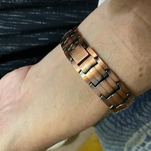 A close-up of a reviewer wearing the Vitalis Copper Magnetic Bracelet on their wrist.