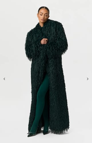 Reviewer wearing the long, dark green Faux Feather Long Coat against a plain background.