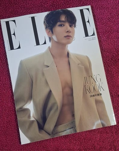 Reviewer's photo of the ELLE Japan magazine cover, showing Jungkook in an unbuttoned beige blazer.