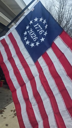 Customer's beautiful 1776 to 2026 Betsy Ross Flag with embroidered stars, hanging outdoors from a pole.