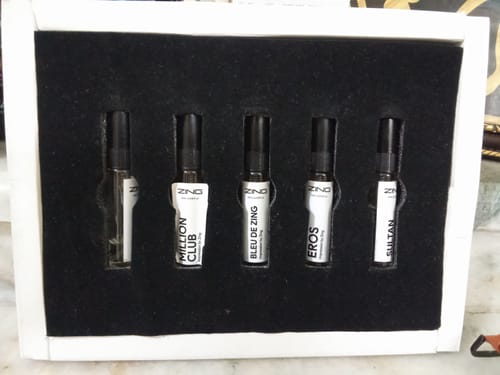 Customer's open Best selling Tester Pack showing five perfume sample vials arranged inside the box.