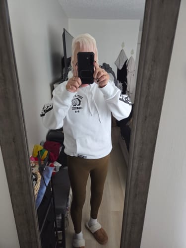 Reviewer takes a mirror selfie showing the fit of the brown, full-length 3D Anti-Cellulite Leggings.