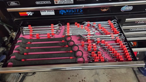 A customer's open tool drawer with wrenches organized by red Toolgrid Wrench Holder Clips on a pink grid.