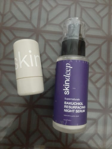 Customer's VELVET FLUSH Lip+Cheek Blush in a white tube, shown next to a bottle of Skindeep night serum.