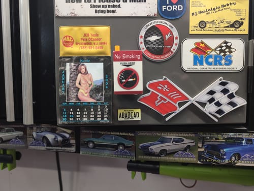 Customer's New Jersey License Plate Pin, converted to a magnet, displayed on a tool cabinet with other car-related items.