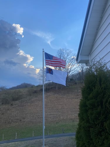 Reviewer's flagpole using the white braided halyard to fly an American flag and a Christian flag.