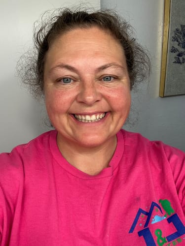 Customer selfie showing her smiling face and skin after using the Grass Fed Tallow & Honey Balm.