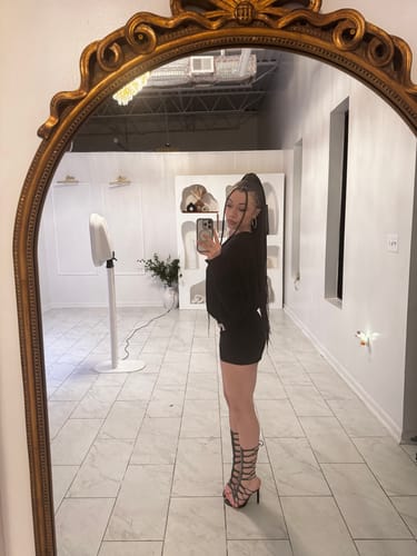 Reviewer taking a mirror selfie showing a side profile of the black Snake Heels.