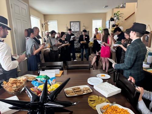 Customers playing the 1920s Murder Mystery Game Kit at a party, dressed in fun costumes and holding character sheets.