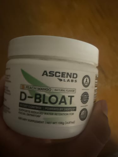 Customer holding their white tub of Ascend Labs D-BLOAT supplement in Peach Mango flavor.