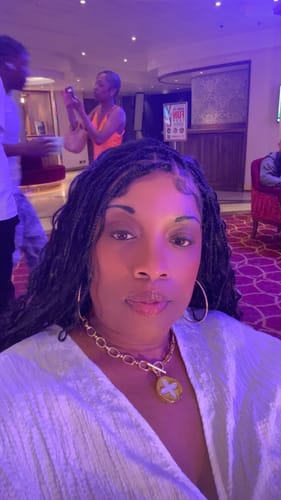 Reviewer wearing the Knotless Bohemian Full Lace wig with all the braids and curls worn down.