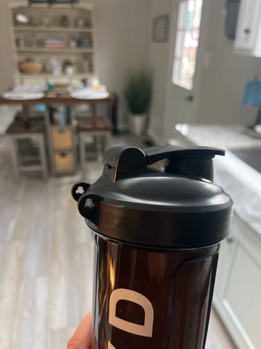 Customer's close-up of the SAVD Shaker Bottle's black lid, showing the broken carry hook.
