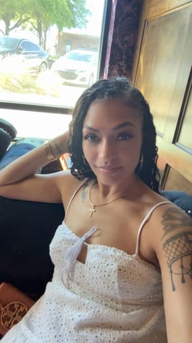 Reviewer showing her styled Ywigs Loose Deep Wave Human Crochet Hair with a braided top and loose curls.