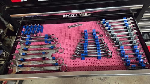 Customer's open tool drawer with sets of wrenches neatly organized by blue Toolgrid Wrench Holder Clips.