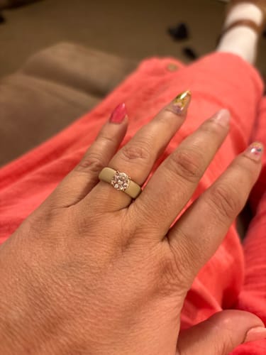 Customer's hand wearing the light-colored Silicone Ring with a large, round solitaire CZ.