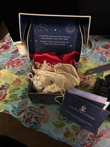 A customer's unboxed VIP Crystal Club monthly tester, showing the presentation box with satin pouches and cards inside.