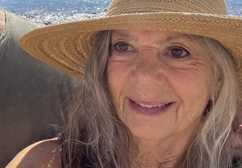 Close-up of a happy customer's face, showing the clear skin results from the Grass Fed Tallow & Honey Balm.