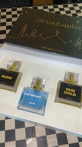 Customer's OUD Supreme BUNDLE with three glass perfume bottles named Rumi, Oud Nirvana, and Oud Gold in a white box.