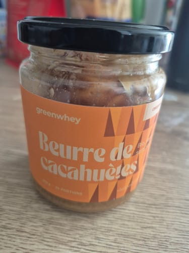Photo d'un client : un pot en verre de Beurre de Cacahuètes Bio avec sa texture croquante visible.