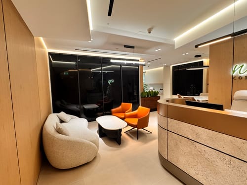 Reviewer's photo of a stylish waiting area featuring a white coffee table and seating from the collection.