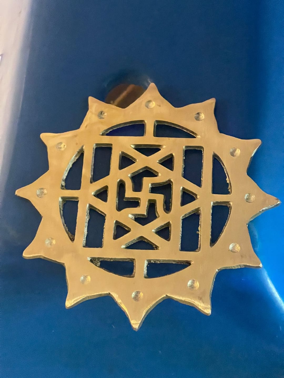 Customer photo review of Brass Swastik with Lotus Helix – Vastu Remedy for Main Door Protection | Evil Eye & Positive Energy Shield | Kitchen/Entrance Placement | 6 x 6 Inch