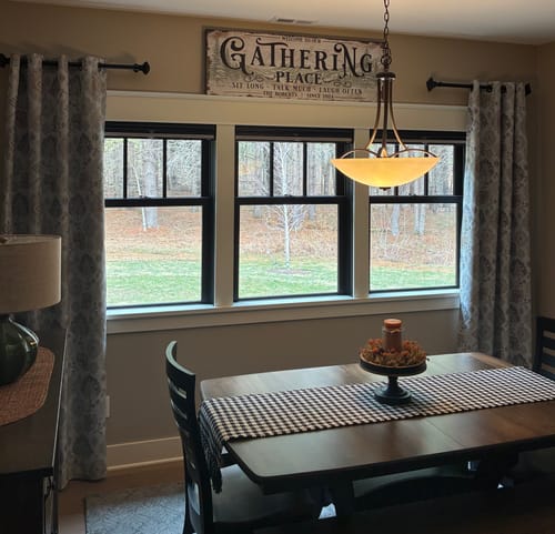 Customer's Gathering Place Personalized Sign hung in their dining room above a set of windows.