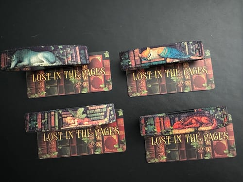 Customer displays all four Lost In The Pages Bracelets, featuring the unicorn, griffin, fairy, and dragon designs.