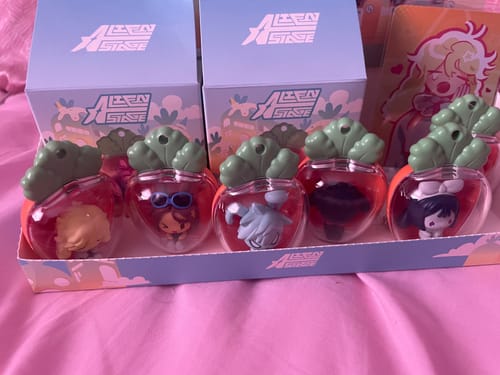 Reviewer's set of Alien Stage Rabbit Series Blind Box figures in their cute radish containers, arranged in the display tray.