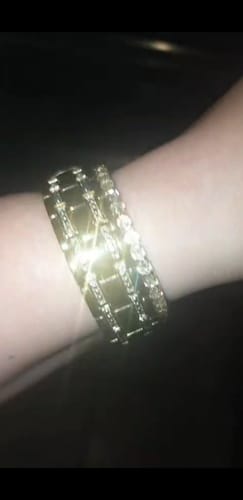 Reviewer shows two sparkling gold-tone bracelets from the bundle deal on their wrist.