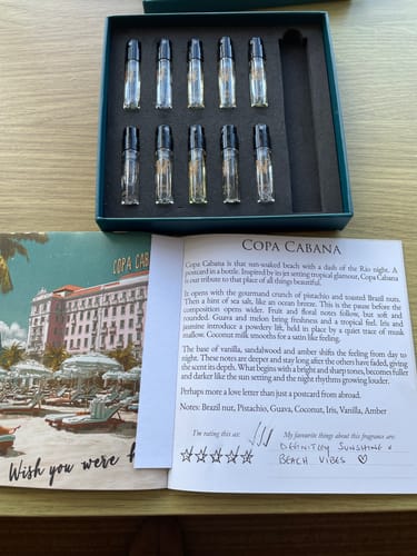 Customer's Limited Edition Discovery Set open on a table with fragrance vials and a card showing handwritten notes about a scent.
