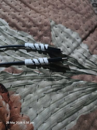Customer shows the white cable protector set installed on the ends of two black cables.