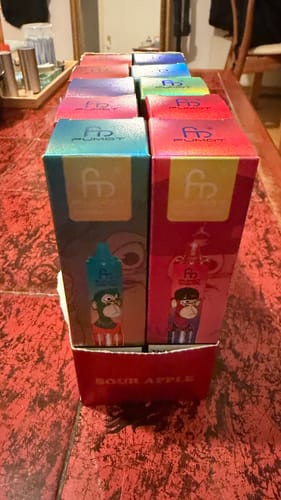 Customer's box of 10 RandM Tornado 15000 Disposable Vapes, showing the colorful individual packages inside.