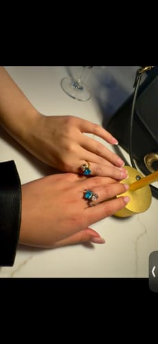 Customer and friend showing off their matching Navae Birthstone Rings with blue stones.