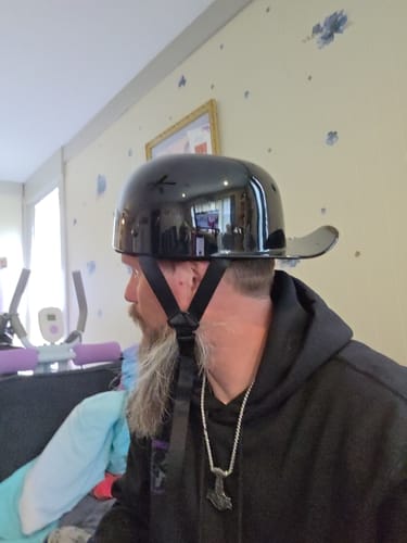 Reviewer from the side wearing the glossy black Baseball Pro Mini helmet, showing its low-profile fit.