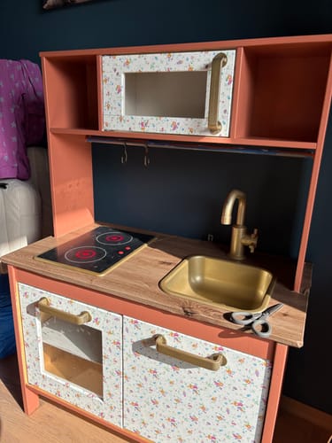Kundes Artisan Oak kontaktplast brukt på benkeplaten til et fargerikt lekekjøkken.