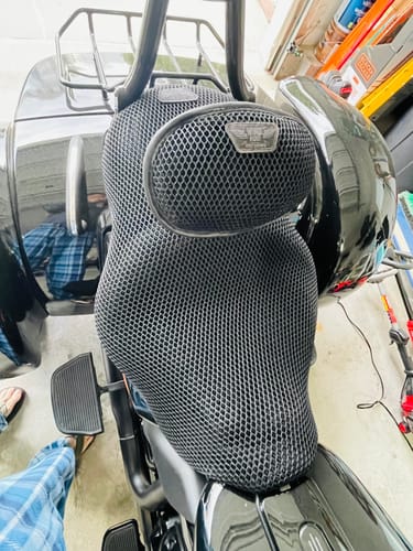 Customer's black mesh Backrest Cover and matching seat cover installed on a black motorcycle in a garage.