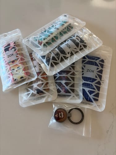Customer's collection of several Non-Interactive Mystery 3-Packs and a keychain in their original packaging.