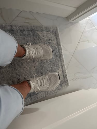 Customer's overhead view of their white athletic shoes, worn with Extra Cushion Insoles.