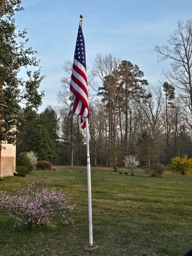 Customer's heavy duty American flag on a tall flagpole in their yard.