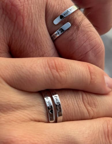 Reviewer shows the adjustable 'I F♡cking Love You Ring' fitting both their hand and their partner's hand.