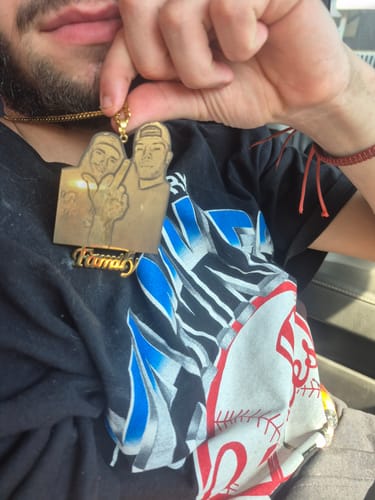 Reviewer holding up their gold Custom Photo Engraved Pendant Necklace with a 'Family' nameplate.