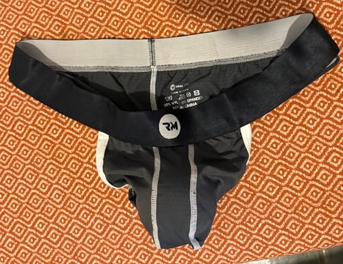 Customer's dark gray Nylon Mesh Bikini Briefs laid flat, showing the inner waistband and logo.