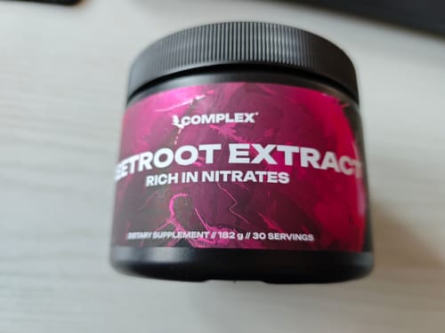 Customer's black tub of Complex Beetroot Extract supplement with a vibrant pink and black label.