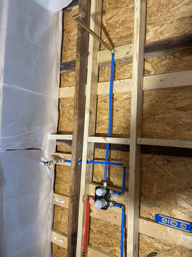 Customer's in-progress installation of the 2-Handle Shower System, showing the exposed plumbing and valve within the wall framing.
